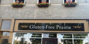 People in windows above Gluten-Free Prairie storefront.