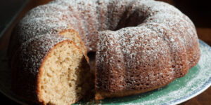 Bundt cake with powdered sugar on plate.