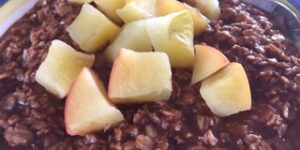 Oatmeal with diced apples in a bowl.