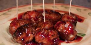 Meatballs with toothpicks and sauce.