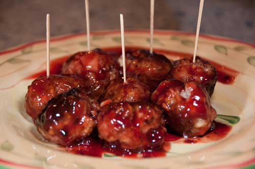 Meatballs with toothpicks and sauce.