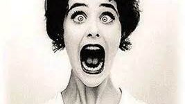 Woman with shocked expression, mouth wide open.