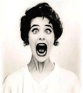 Woman with shocked expression, mouth wide open.