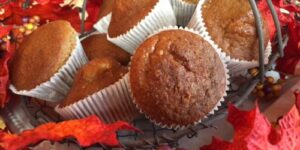Basket of muffins with autumn leaves decoration.