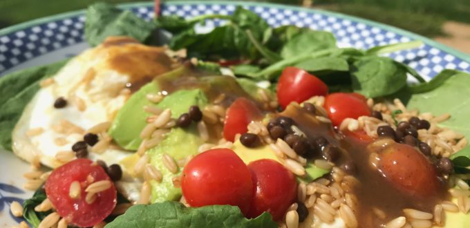 Close-up of a fresh salad with cherry tomatoes and greens.