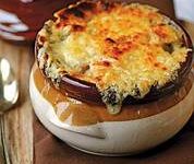 A bowl of baked cheesy mushroom soup with a golden crust.