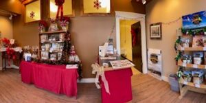 Cozy shop corner with red tablecloths and decorative items on display.