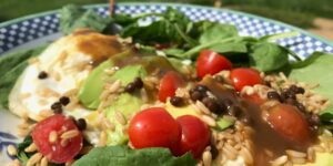 Close-up of a fresh, colorful salad with cherry tomatoes and greens.