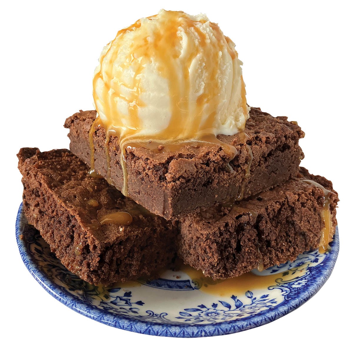 Brownies topped with vanilla ice cream on a decorative plate.